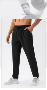 Detail of men's black straight sports trousers featuring elastic drawstring waist and side pocket