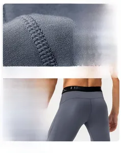 Close-up of flatlock seams and wide elastic waistband on men's gray compression leggings