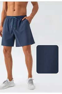 Close-up of navy sports shorts featuring breathable striped texture and drawstring waist
