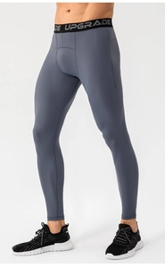 Detail of gray compression pants with wide elastic waistband featuring DE UPGRADE lettering