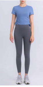 Detail of blue cropped sports top with side drawstring ruching and high waist yoga pants