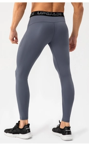 Detail of men's compression pants with elastic waistband and high-stretch fabric fit