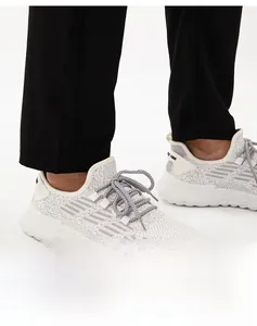 Close-up of quick-dry sports trousers hem with breathable mesh sneakers on model