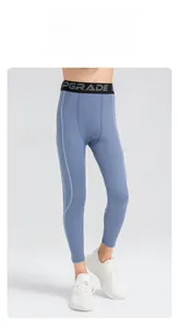 Detail view of boys blue compression sports pants with high elastic waist and PGRADE logo