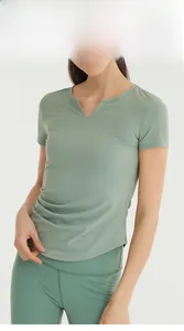Detail of sage green yoga t-shirt featuring a V-neck slit and moisture-wicking fabric