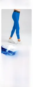 Detail of blue boys' sports leggings showing 80% nylon fabric and UPGRADE waistband