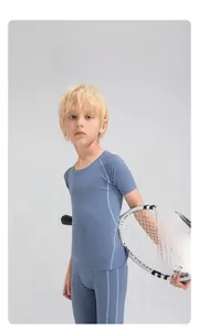 Boy's athletic compression set with ergonomic seams in misty blue quick-dry fabric