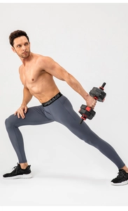 Detail of wide elastic waistband with UPGRADE lettering on men's grey compression pants