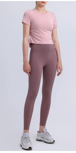Detail of light pink yoga top with side drawstring and high waist fitness leggings
