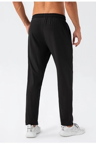 Rear view of black quick-dry men's sports pants showing elastic waist and straight fit