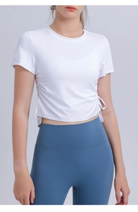 Detail of white sports top with side drawstring ties and breathable quick-dry fabric
