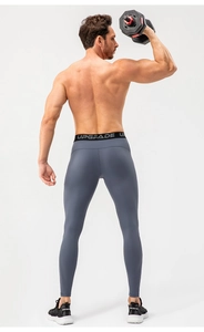 Rear view of men's dark grey high-stretch compression pants with an elastic logo waistband