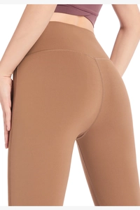 Détail du pantalon de yoga évasé taille haute avec couture galbante et tissu doux extensible