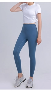 Detail view of white yoga crop top with adjustable side drawstrings for fitness