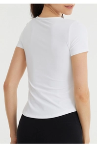 Slim fit white yoga t-shirt showing breathable fabric and flattering back silhouette