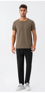 Detail of tan brown quick-dry mesh t-shirt and breathable black athletic pants on model