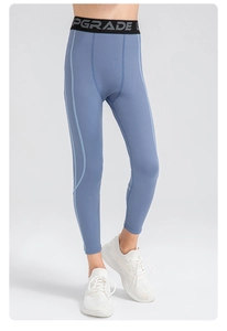 Detail of high-elasticity breathable fabric and UPGRADE waistband on boys' sports tights
