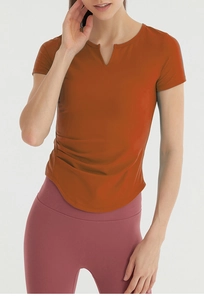 Detail view of quick-dry terracotta yoga t-shirt with V-neck and side ruched drawstring
