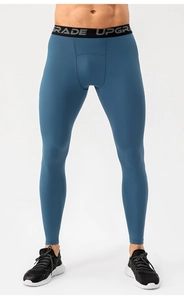 Close-up of the elastic waistband with UPGRADE lettering on blue compression pants