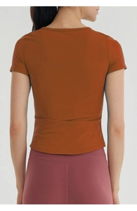 Rear view of burnt orange slim fit yoga T-shirt with breathable quick-dry fabric