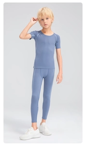 Full body view of boys gray compression sports set with tight shirt and leggings