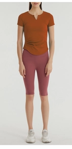 Detail view of caramel yoga t-shirt with side drawstring and high waist fitness shorts