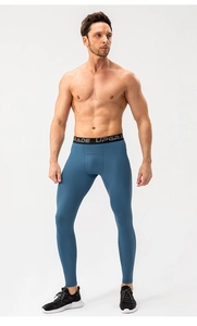 Close-up of men's athletic compression pants featuring a high-elastic contrast waistband