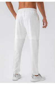 Detail of men's white quick-dry sports trousers with elastic drawstring waistband