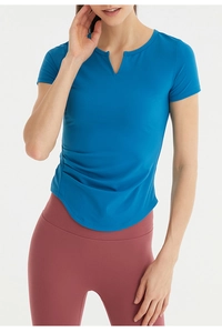 Detail of blue quick-dry yoga t-shirt with side ruched texture and curved hemline