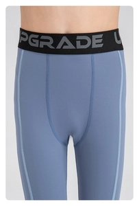 Detail of blue compression pants with high elastic fabric and UPGRADE waistband