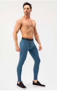 Detail of high-elastic men's blue compression leggings with UPGRADE lettered waistband