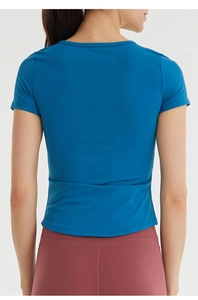 Rear view of slim fit yoga t-shirt for women in navy blue featuring quick-dry fabric
