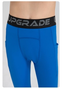 Macro detail of kids blue compression leggings featuring side pocket and elastic waistband