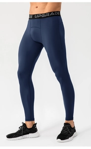 Close-up of men's navy blue compression leggings featuring a black UPGRADE elastic waistband