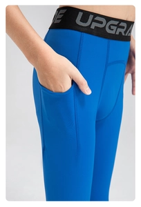 Detail view of royal blue athletic leggings with side pocket and elastic branded waistband