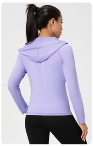 Vue arrière d'une veste de yoga à capuche violet clair ajustée pour femmes au tissu élastique