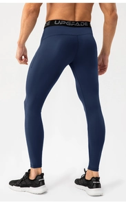 Rear view of men's navy blue compression tights with elasticated logo waistband