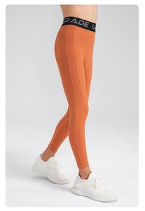 Close-up of boys orange compression pants with high-elastic waistband and athletic design