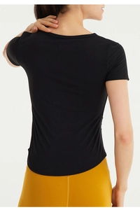Slim fit black quick-dry yoga T-shirt back view showing breathable stretch fabric detail