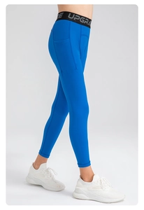 Detail view of boys' blue compression pants with side pocket and elastic upgrade waistband