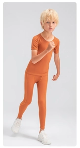 Detail view of boys' orange high-elasticity quick-dry compression sports set for basketball