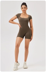 Detail view of square neck dark brown compression yoga bodysuit with short sleeves and shorts