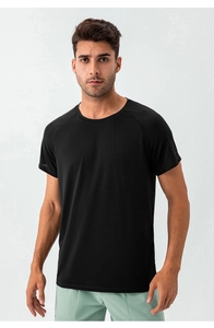 Detail of black men's quick-dry sports t-shirt showing breathable micro-mesh fabric texture