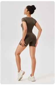 Side view detail of a form-fitting dark brown short sleeve yoga romper with back seams