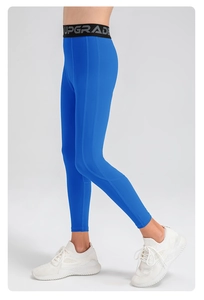 Detail of high-waist blue sports leggings with UPGRADE letter waistband and side stitching