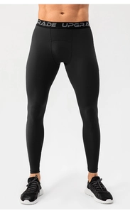 Detail of men's compression leggings showing wide elastic waistband with UPGRADE lettering