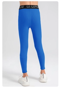 Detail of high-waist blue sports leggings with black elastic waistband and UPGRADE text