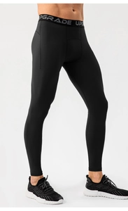 Detail of high-elastic black men's compression pants with UPGRADE waistband text