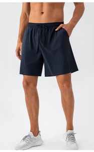 Detail of navy blue quick-dry athletic shorts with elastic waistband and black drawstring