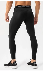 Detail view of high-elasticity compression pants featuring wide upgrade lettering waistband